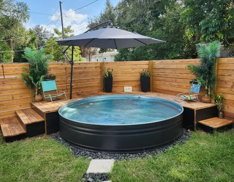 Black Stock Tank Pool with Modern Wooden Platform