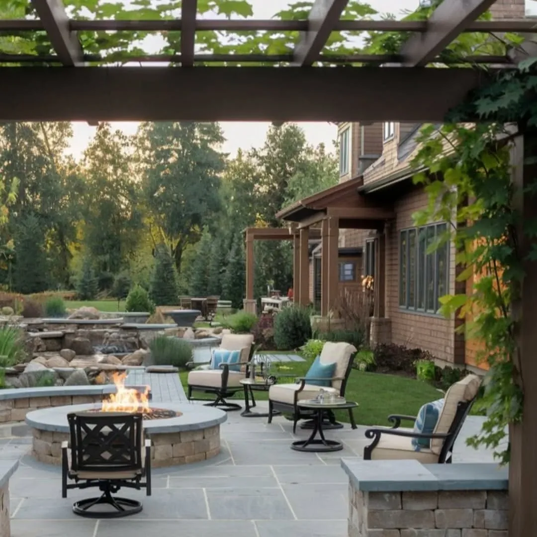 Elegant Stone Fire Pit with Pergola and Water Feature