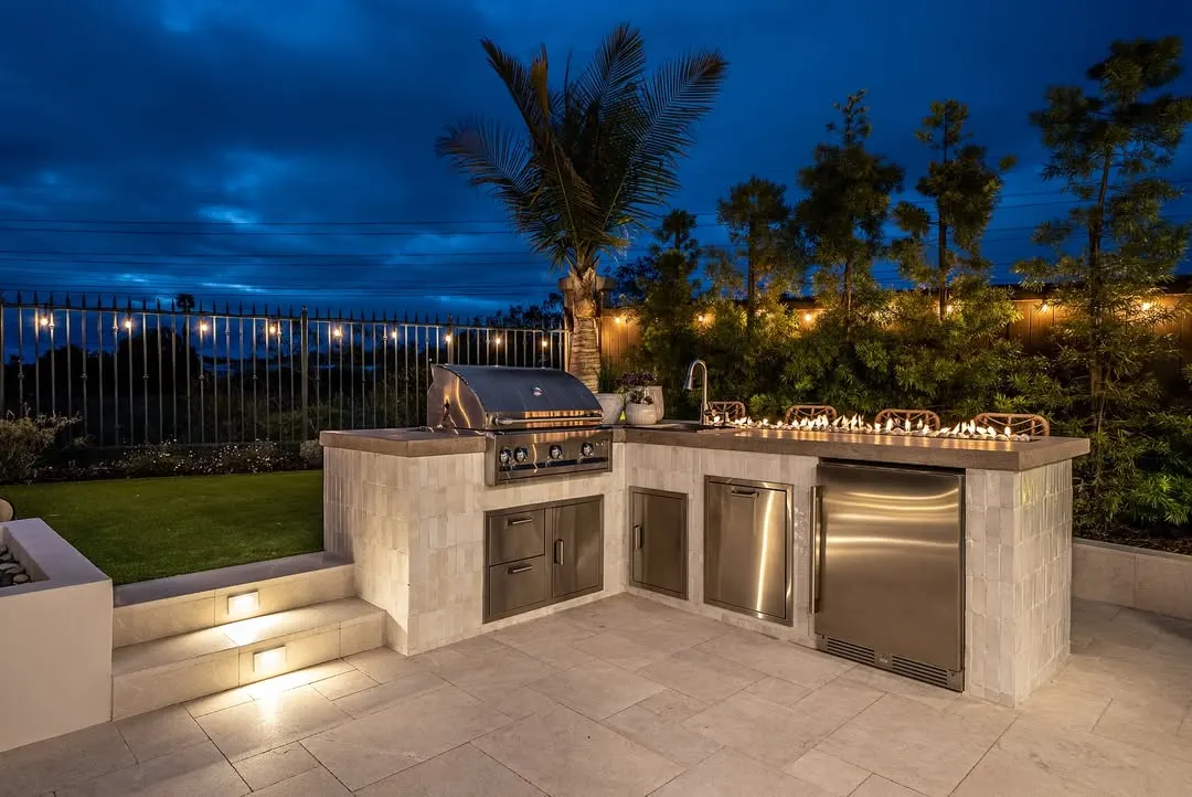 Evening L-Shaped Outdoor Kitchen with Fire Feature