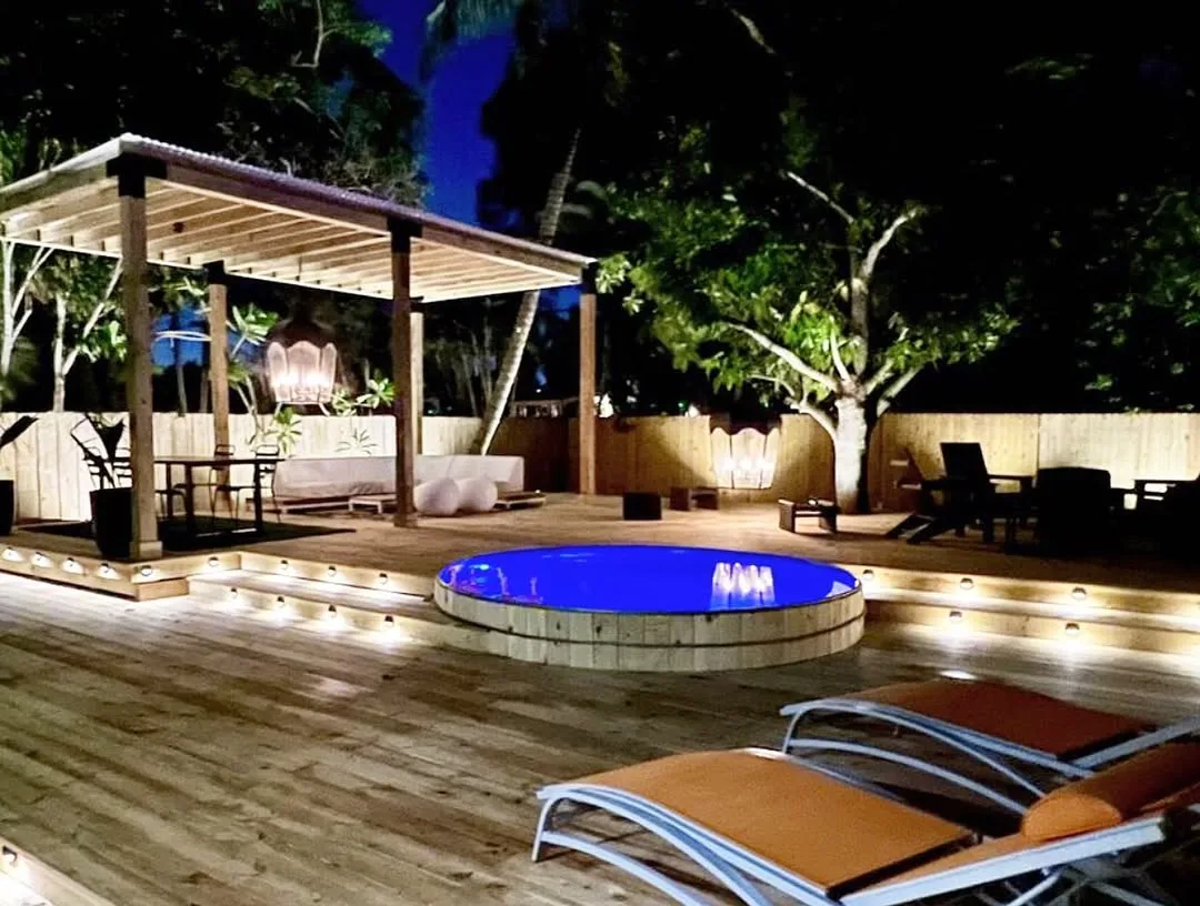 Illuminated Evening Stock Tank Pool with Pergola