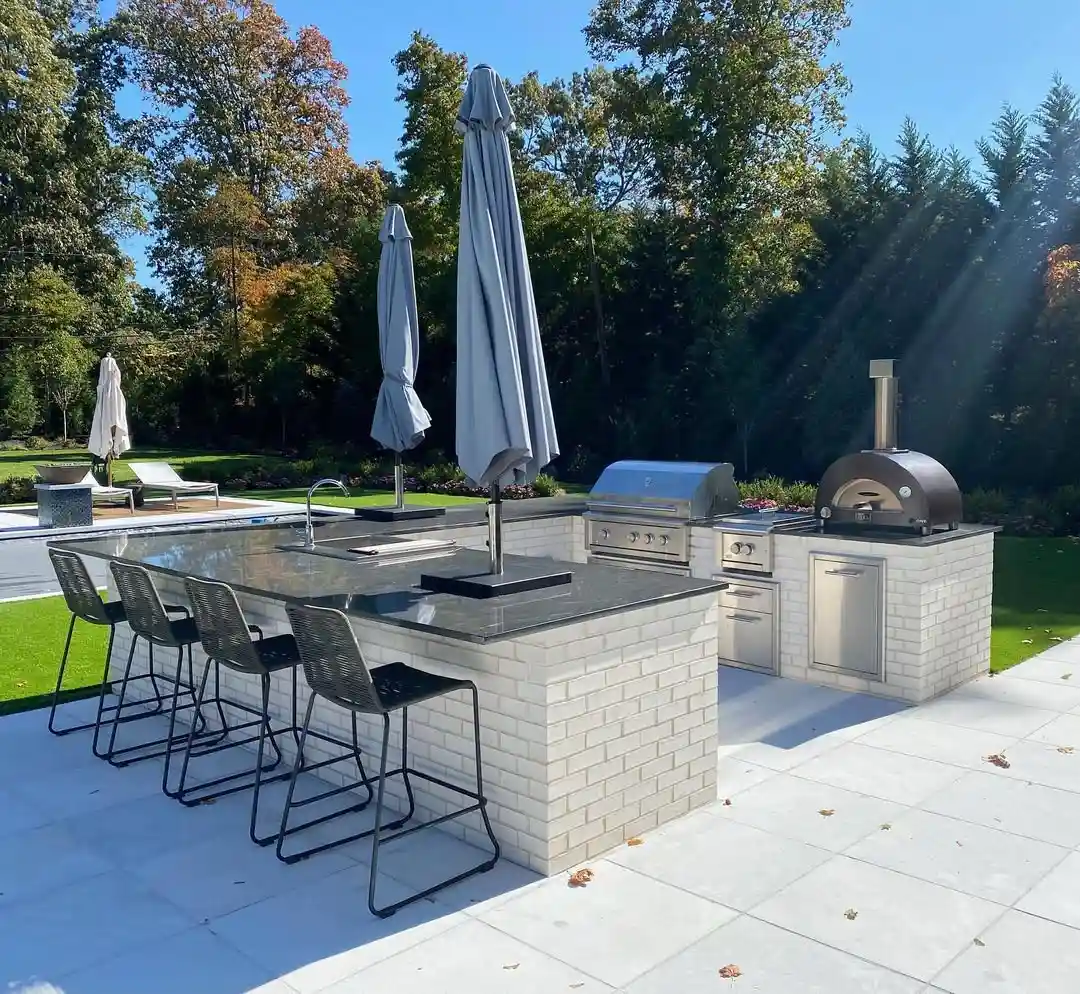 Resort-Style Outdoor Kitchen with Pizza Oven and Bar Seating