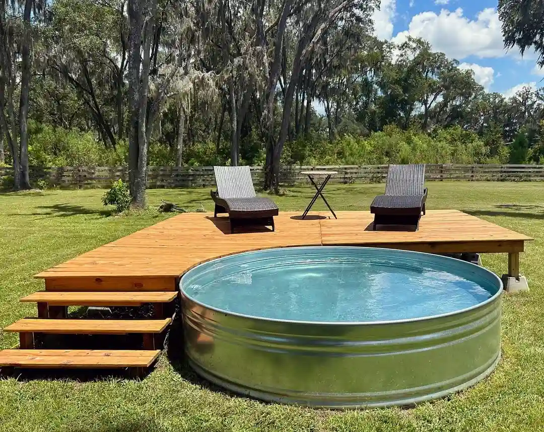Rustic Stock Tank Pool with Custom Wooden Deck and Steps
