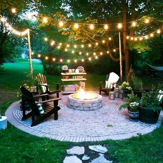 Circular Brick Patio Fire Pit with String Light Canopy
